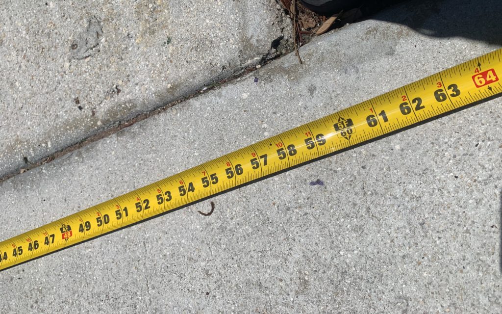 Tape measure on sidewalk